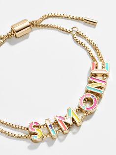 The brightest among our collection of Custom Slider Bracelets is our Multi Enamel style. This special bracelet features two strands of a box chain, an easily adjustable pull-tie closure, and vibrant gold and enamel beads. Choose a name, initials, or favorite phrase to customize your bracelet with - it's sure to be your new everyday staple. See our Letter Key for all options available. Preppy Accessories, Preppy Jewelry, Slider Bracelet, Early Black Friday, Enamel Beads, Name Initials, Jewelry Accessories Ideas, Dope Jewelry, Gold Bead Bracelets