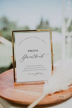 a table with a sign and some feathers on it