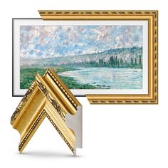 two gold frames with paintings on the wall and one has a painting hanging above it