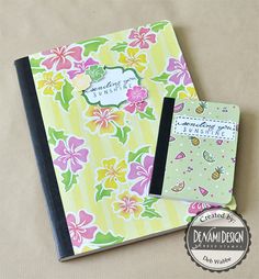 a notebook with a notepad attached to it and a flower pattern on the cover