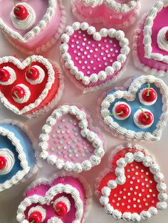 heart shaped cakes are arranged on a table