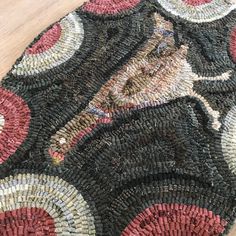 a close up of a rug on a wooden floor