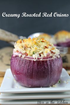 a close up of an onion on a plate with other food items in the background