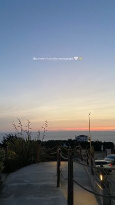 the view from the restaurant looking out over the ocean at sunset or sunrise with an airplane flying in the sky