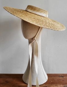 This is a natural straw hat with a shallow crown and a large brim. It has cream coloured grosgrain ribbons attached on both sides of the inside belt. These can be tied under the chin, or backside of your neck The hat is free size and attaches with a discreet millinery elastic, worn around the back of the head. Height of the crown:4cm Width of the brim: 13,5 cm Parisian Winter, Tulle Headband, Bohemian Hats, Straw Boater Hat, Floppy Straw Hat, Straw Visor, Straw Boater, Summer Hats Beach, Spring Hats