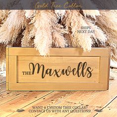 a wooden sign that says the maxwells on it and some dry grass behind it