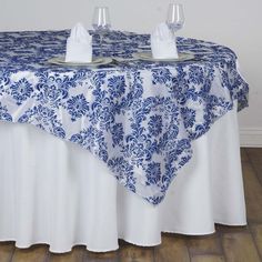 a blue and white table cloth with two glasses on it