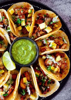 a plate filled with tacos and guacamole