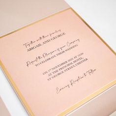 the inside of a pink and gold wedding card with black ink on it's envelope