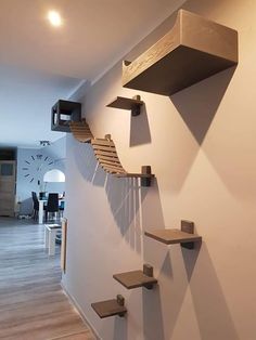 there are some shelves on the wall in this living room that is designed to look like a staircase