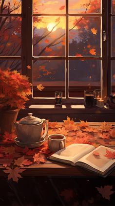 an open book sitting on top of a table next to a window with autumn leaves