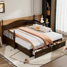 a bed sitting on top of a wooden floor next to a white rug and window