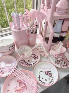 hello kitty dishes and utensils on a counter