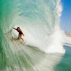 a man riding a wave on top of a surfboard