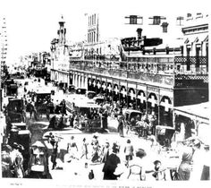 an old black and white photo of people on the street