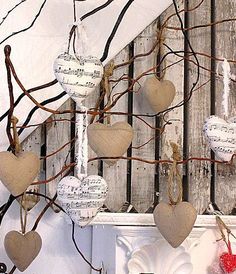 several hearts are hanging from a tree branch