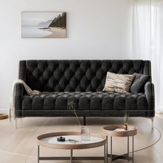 a living room with a black couch and coffee table