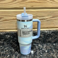 a blue coffee cup sitting on top of a counter