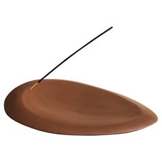 a brown plate with a stick sticking out of it