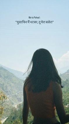 a woman standing on top of a lush green hillside under a blue sky with an inspirational quote above her