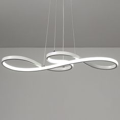 a modern chandelier with three lights suspended from it's center and two circular rings at the bottom