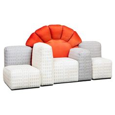 an orange and white chair sitting on top of a set of four stools next to each other