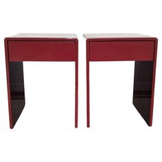 a pair of red end tables sitting next to each other