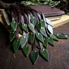 several green leaves are laying on top of a book