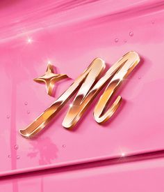 a pink car with gold lettering and stars on the front end, is seen in this image