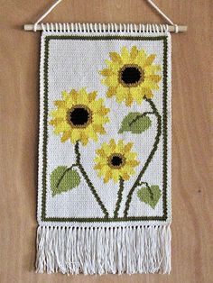 a wall hanging with sunflowers on it