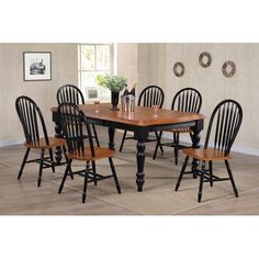 a dining room table with six chairs and a potted plant in the corner on the floor