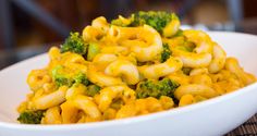 a white bowl filled with macaroni and broccoli