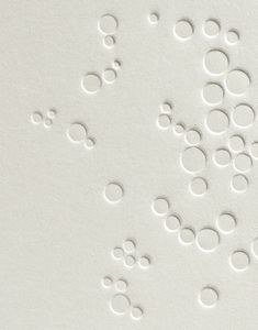 several circles are arranged in the middle of a white paper background that has been cut into smaller circles