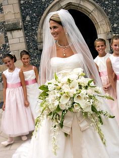 a bride standing in front of her wedding party