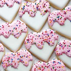 many decorated heart shaped cookies with sprinkles