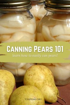 jars filled with pears sitting on top of a wooden table