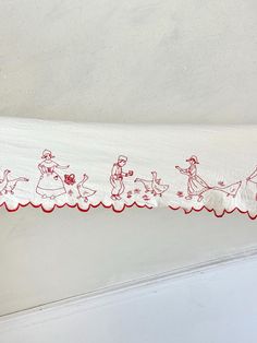 a red and white christmas ribbon with santa's sleighs on it