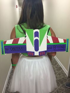 a girl in a dress is holding a sign that says to obitreath and beyond