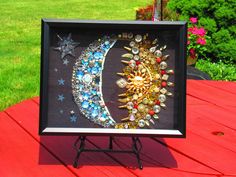 a painting on a wooden table in the shape of a crescent with stars and moon