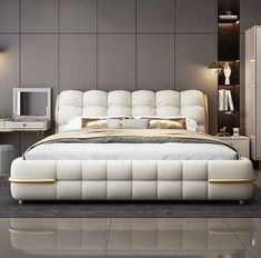 a modern bedroom with white and gold furniture