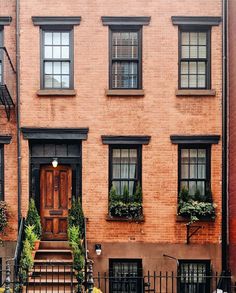 an apartment building with stairs leading up to the front door