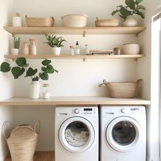 a washer and dryer sitting next to each other on top of a wooden shelf