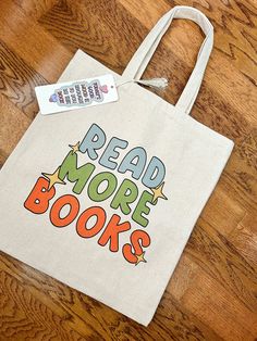 Who doesn't love a good bookish bag!?! This Read More Books bag is the perfect thing to carry all of your bookish things. This 100% cotton bag comes in one size - 15" x 16"- perfect for everyday wear. It is durable and will last for years. The bag features 20" handles (made from the same canvas), making it easy to carry even with a week's worth of shopping. .: 100% cotton canvas .: Heavy fabric (12 oz/yd² (406.9 g/m .: Sewn-in label Best Tote Bags, Read More Books, Book Tote Bag, Girls Tote, Canvas Making, Book Shop, Bookish Things, Cute Tote Bags, Diy Book