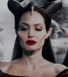 a woman with horns on her head and red lipstick