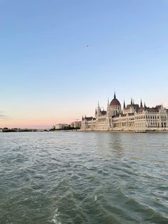 a large building sitting on the side of a river