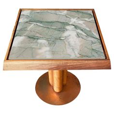 a square marble top table with brass base and wooden frame on an isolated white background