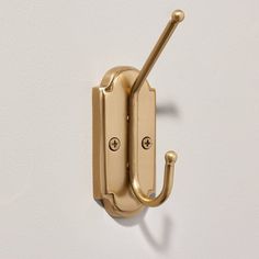 a gold door handle on a white wall