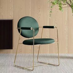 a green chair sitting on top of a carpeted floor next to a wooden wall