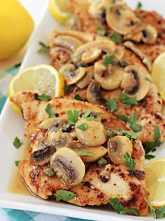 chicken with mushrooms and lemon slices on a plate