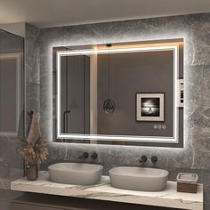 a bathroom with two sinks and a large mirror above it's countertop area